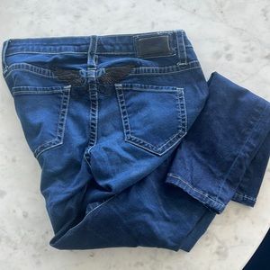 Robins Jean size 27 denim with black stitching on wings